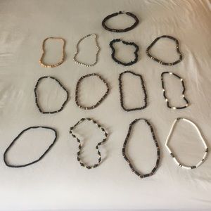 Lot of thirteen (13) surfing short necklaces